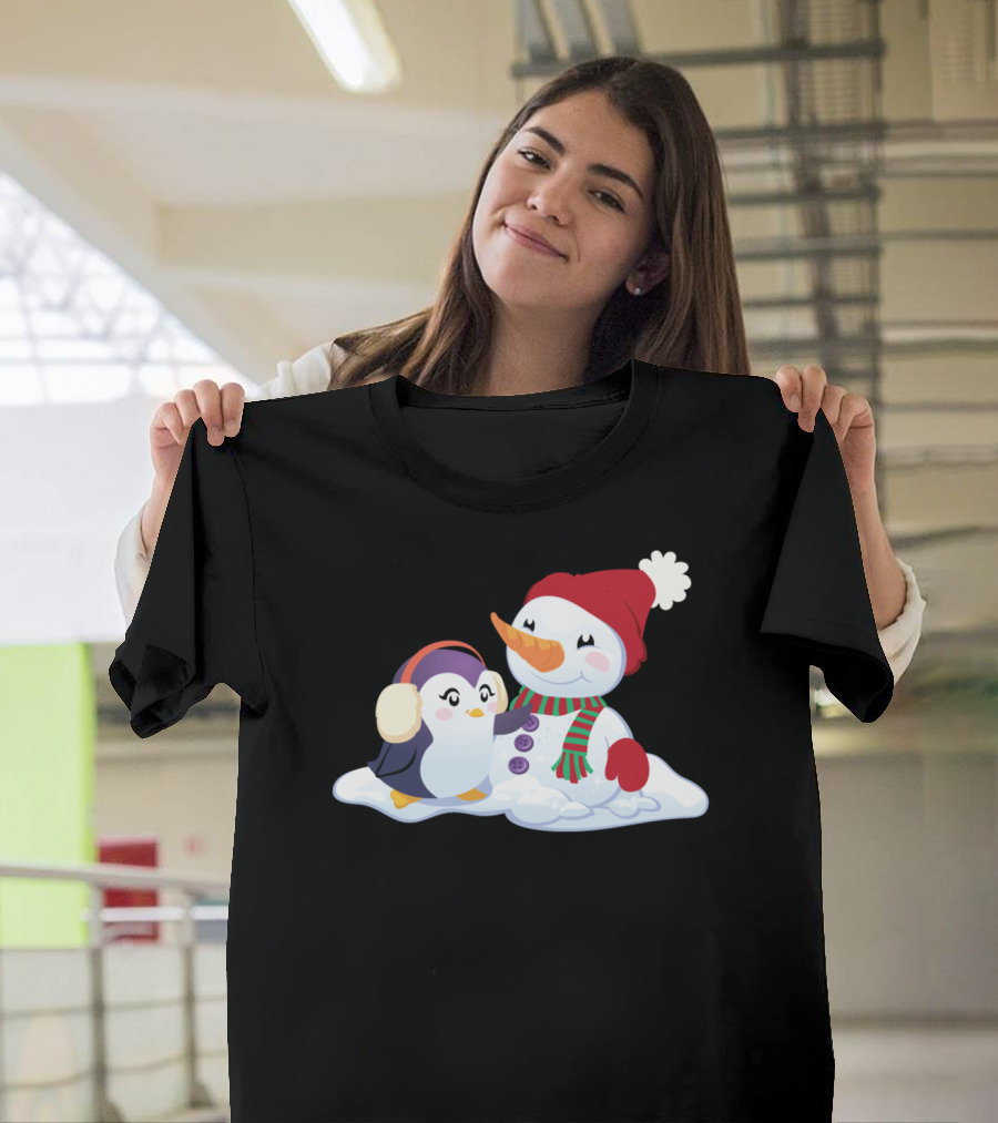 Penguin and Snowman Cozy Winter Companions in Snowy Scene T-Shirt