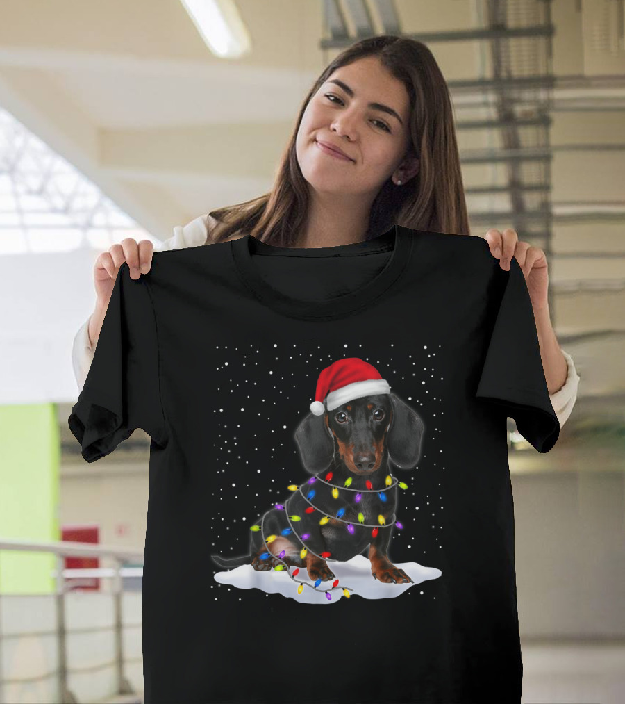 Dachshund Santa Hat Wrapped in Christmas Tree Lights in Snow with Falling Snowflakes T-Shirt
