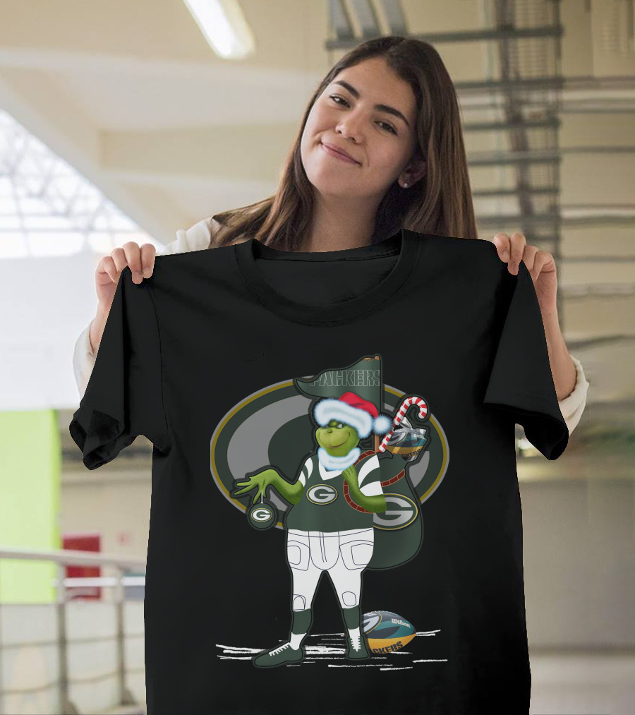 Grinchxmas Green Bay Packers Santa Hat Grinch Holding Helmet and Candy Cane T-Shirt