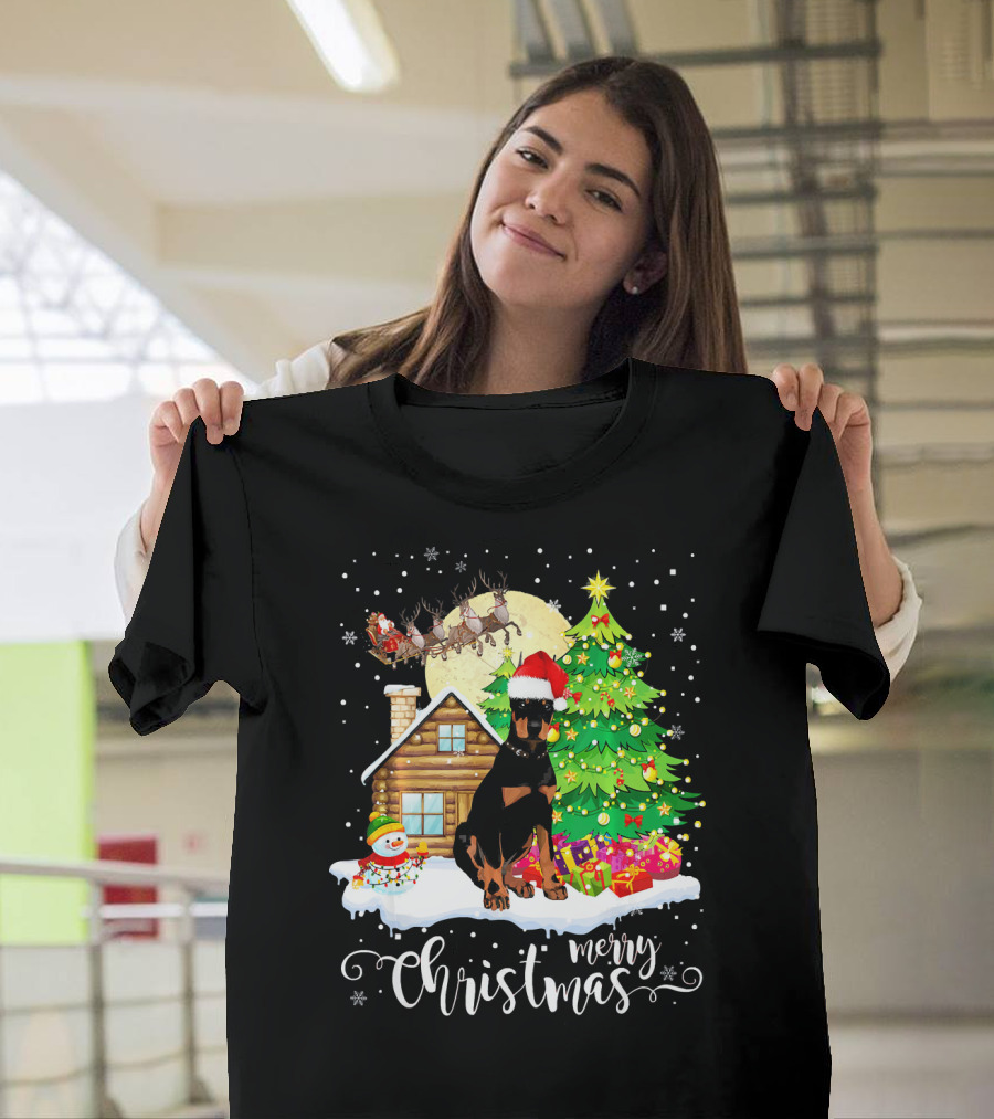 Merry Christmas Doberman with Santa Hat by Christmas Tree and Snowman T-Shirt