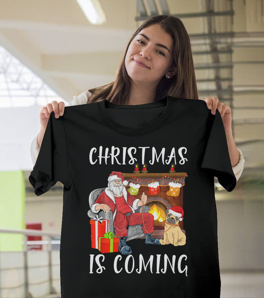 Christmas Is Coming Santa Claus by Fireplace with Dog and Gifts T-Shirt