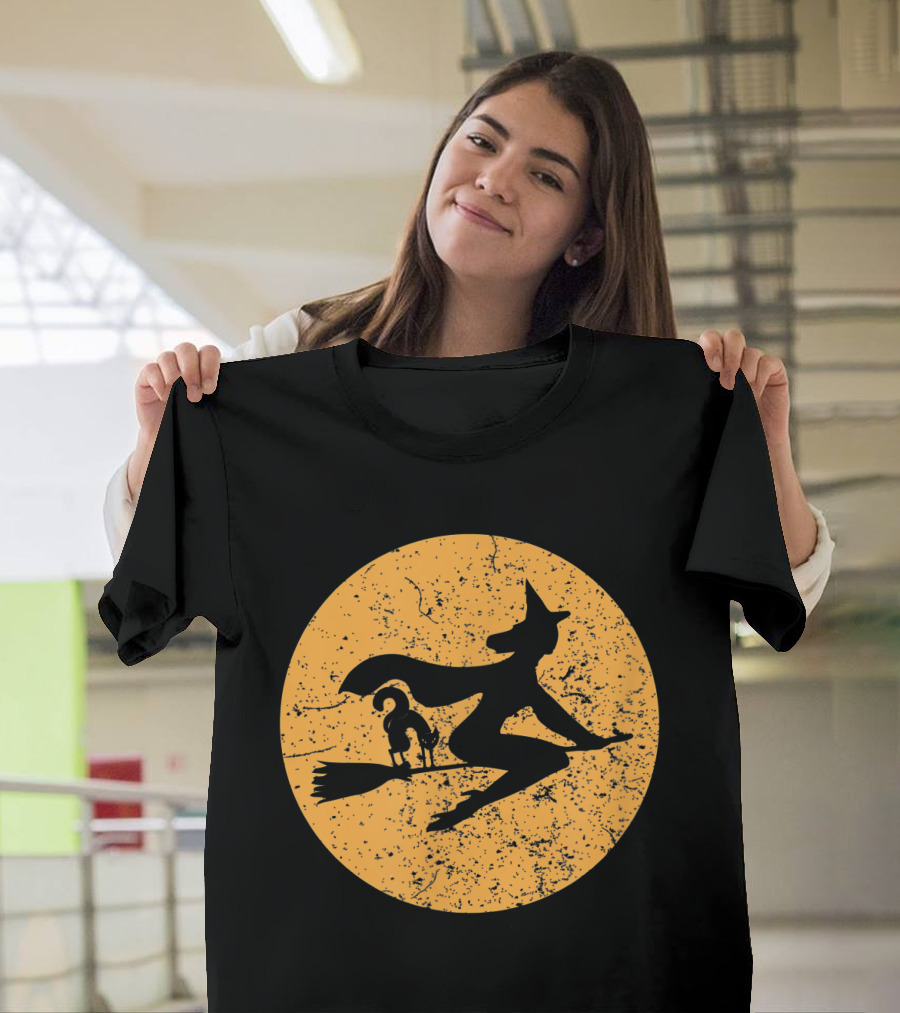 Witch on a Broomstick with Cat Silhouette Against Moon Background T-Shirt