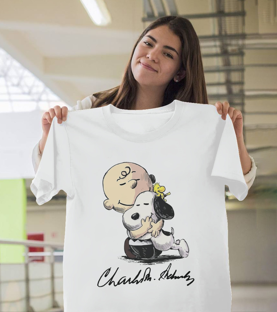 Snoopy And Charlie Brown Hugging By Charles M. Schulz T-Shirt