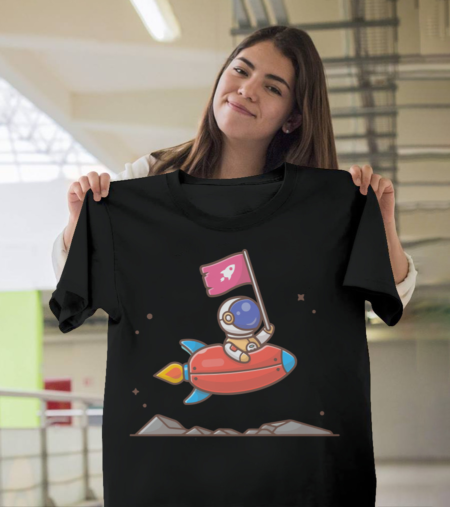 Cute Astronaut Holding Flag on Rocket in Space Scene T-Shirt