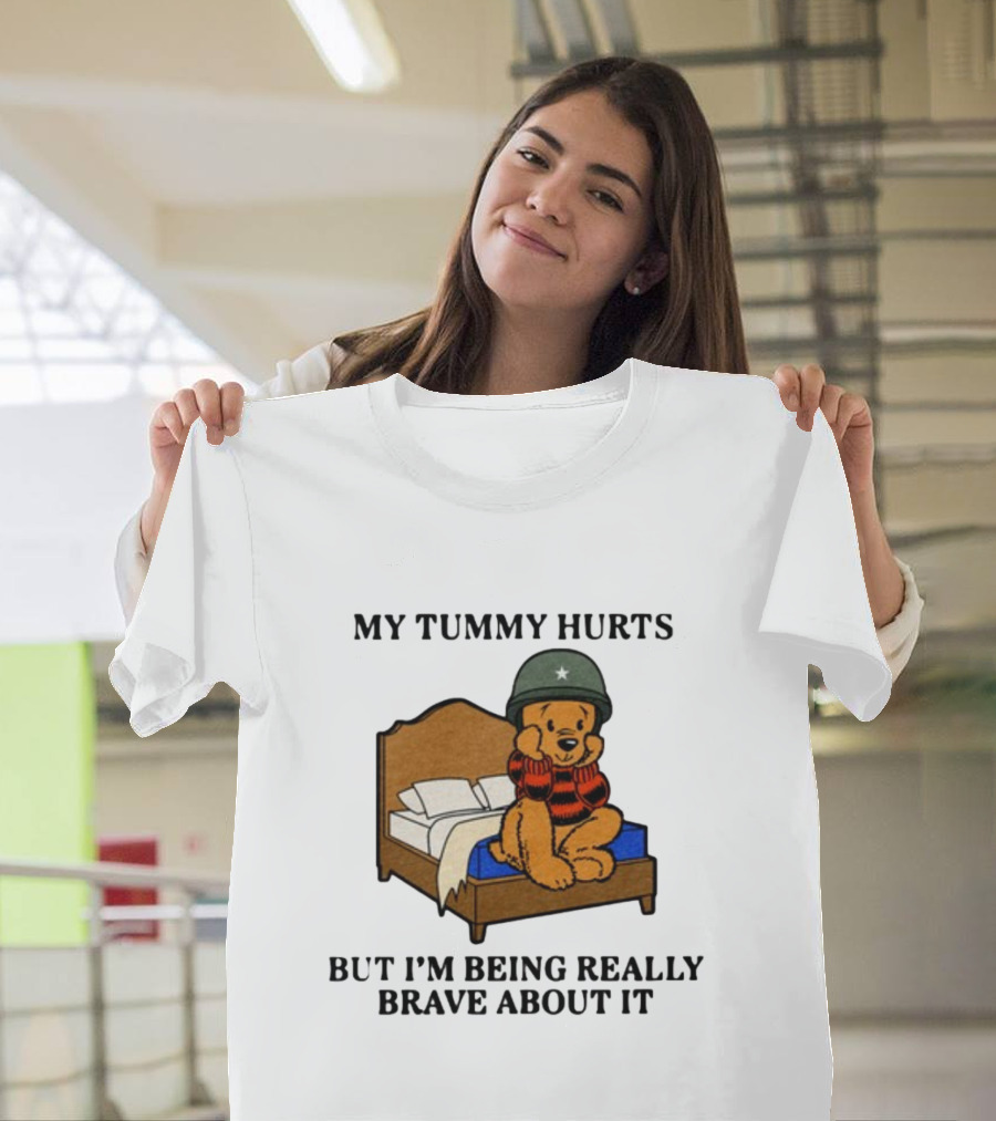My Tummy Hurts But I'm Being Really Brave About It Bear in Helmet Sitting on Bed T-Shirt