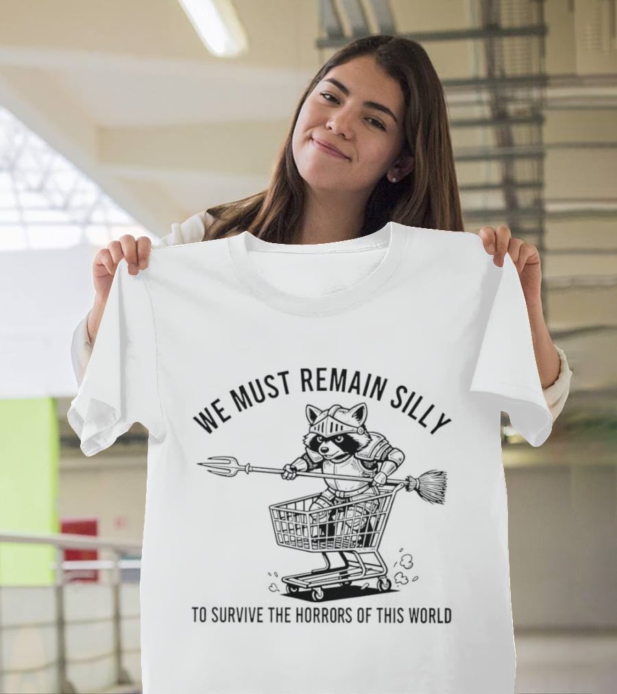 Raccoon Knight In Shopping Cart We Must Remain Silly To Survive The Horrors Of This World T-Shirt