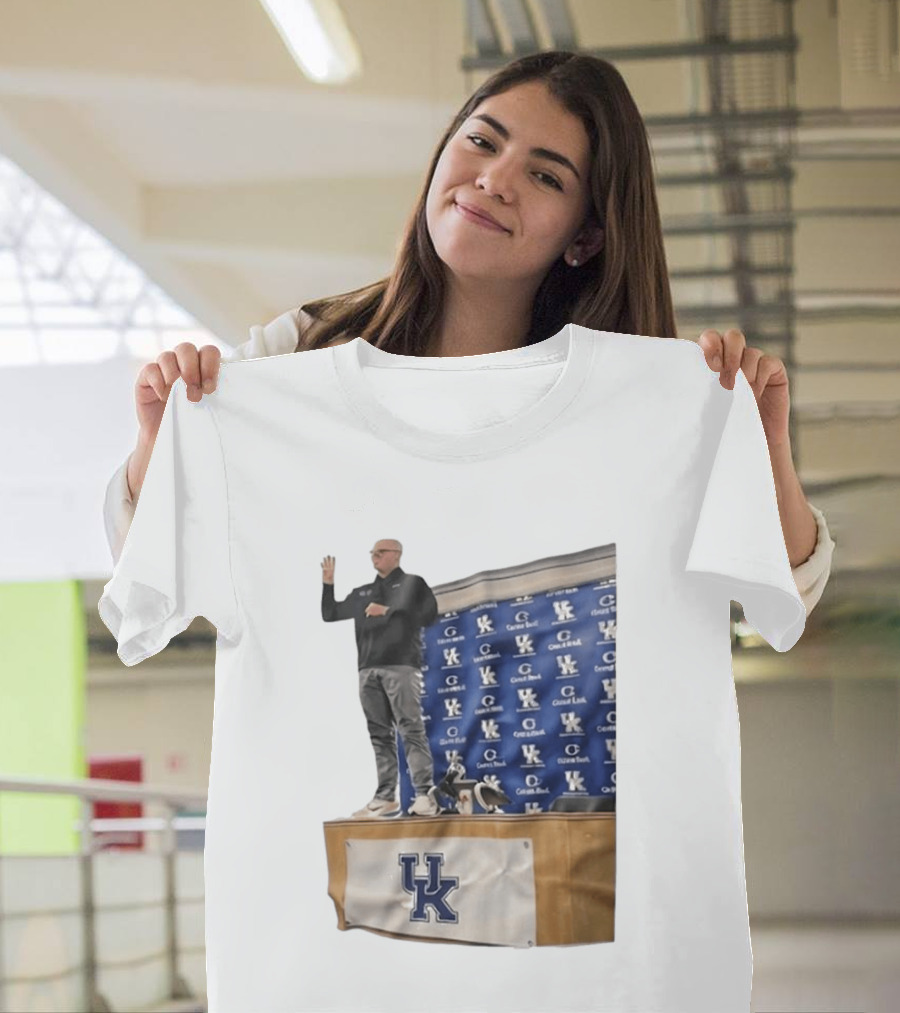 UK Volleyball Coach Craig Skinner Standing On Table With UK Logo And Awards T-Shirt