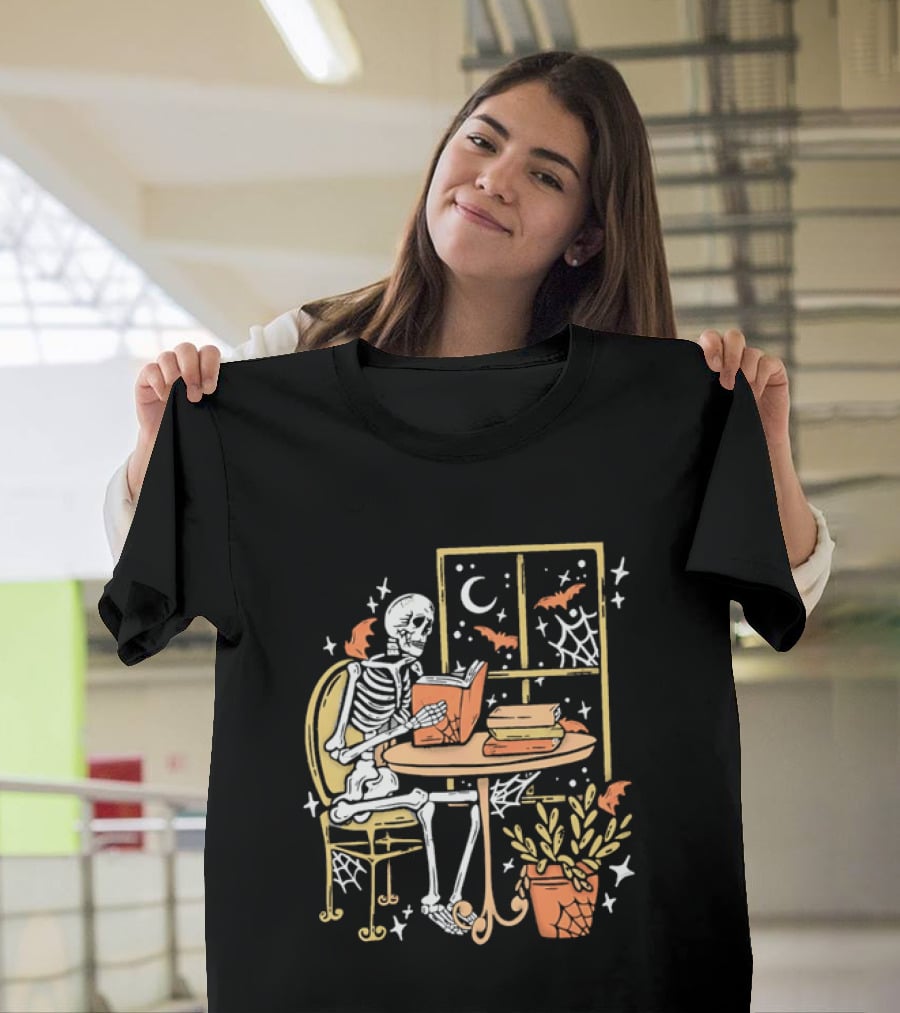 Cartoon Skeleton Reading Under Crescent Moon With Bats Orange Book Table Window T-Shirt