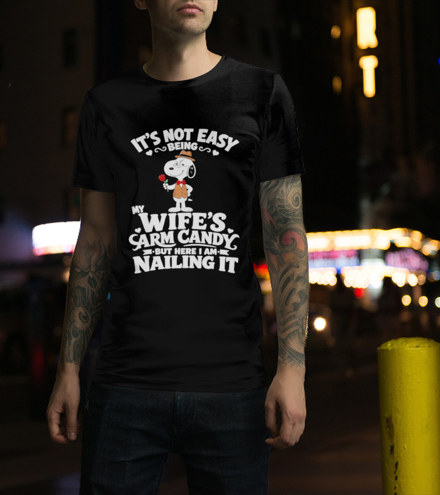 Snoopy It's Not Easy Being My Wife's Arm Candy But Here I Am Nailing It T-Shirt