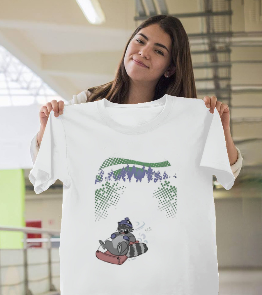 Raccoon Sledding In Winter Forest Scene With Evergreen Trees And Snowflakes T-Shirt