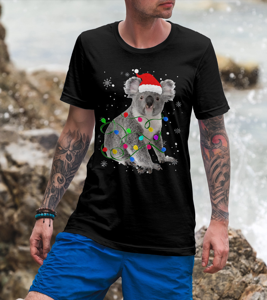 Koala Wrapped In Christmas Lights Wearing Santa Hat With Snowflakes Matching Fam T-Shirt