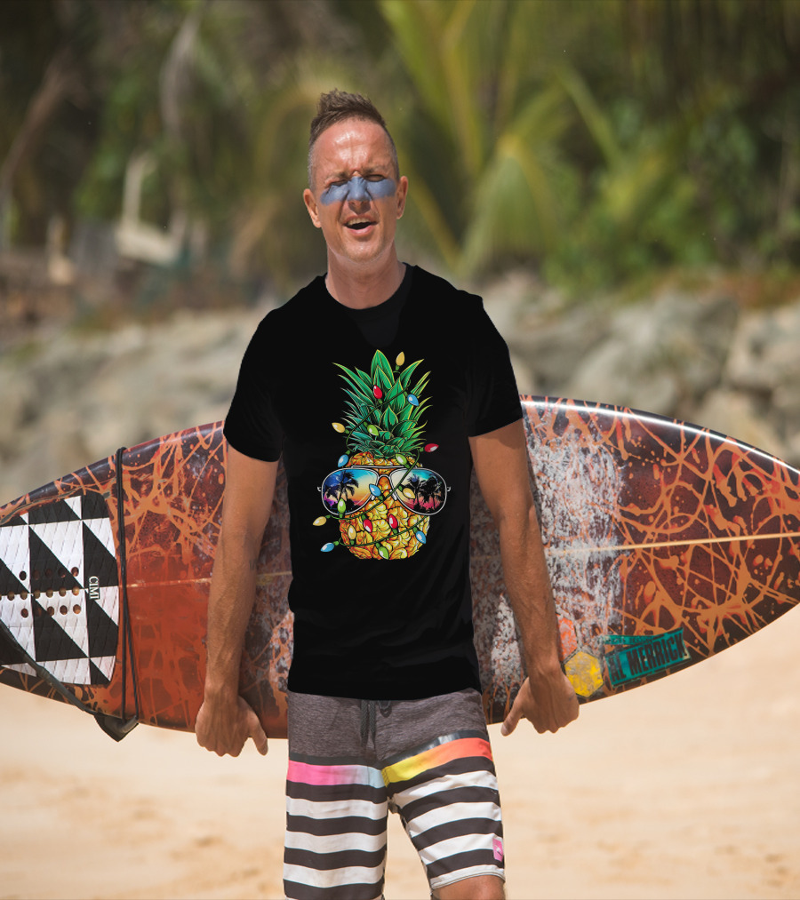 Pineapple Wrapped In Christmas Lights With Sunglasses Reflected Sunset And Palm Trees T-Shirt