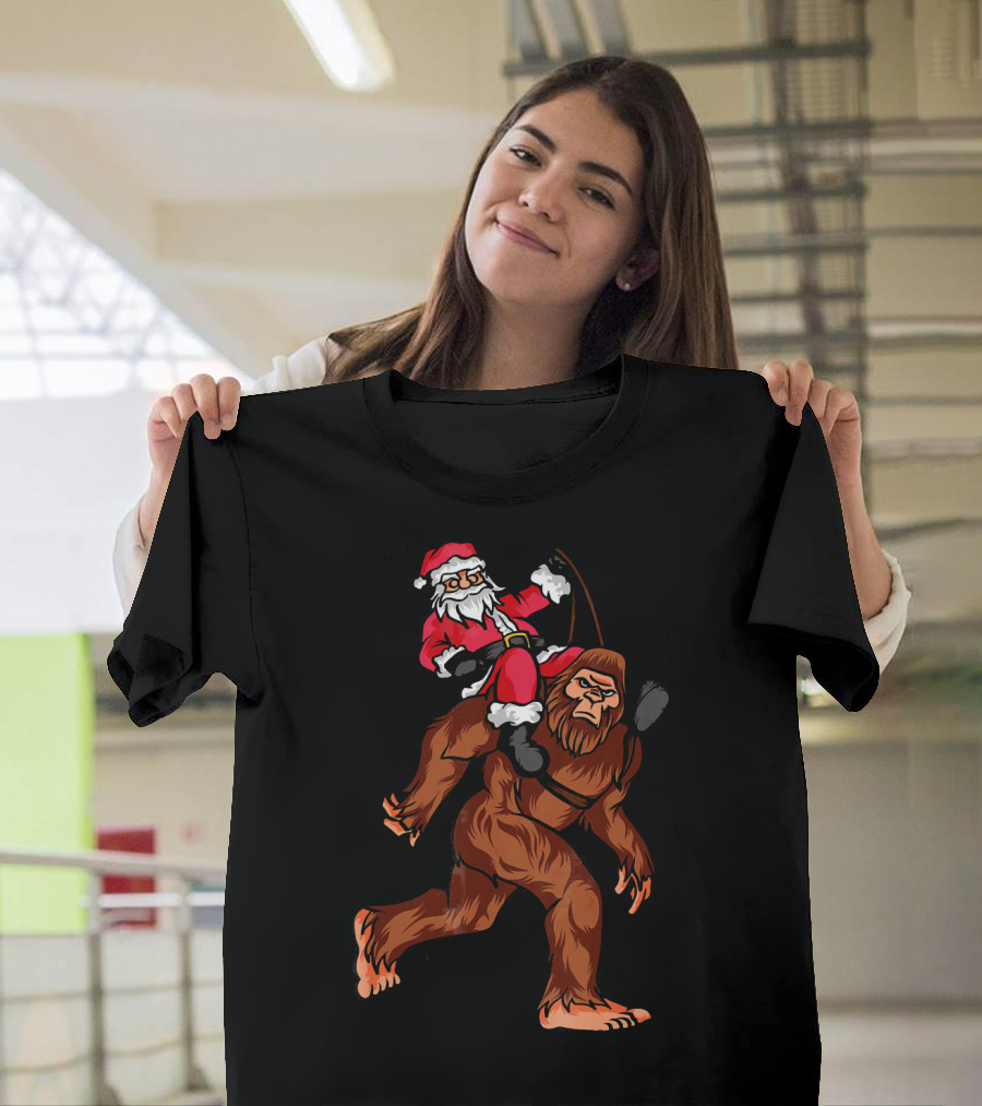 Bigfoot Carrying Santa Claus In Christmas T-Shirt